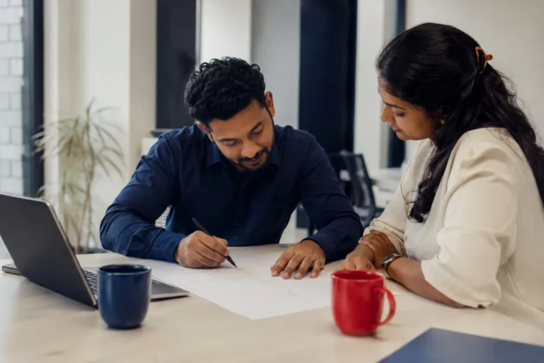 Consultant and client planning a project together at a desk