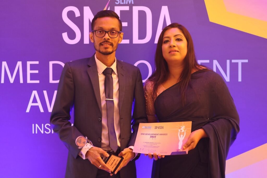 Ants Creation representatives at the SLIM SME Development Awards 2022 holding the Bronze Award trophy and certificate